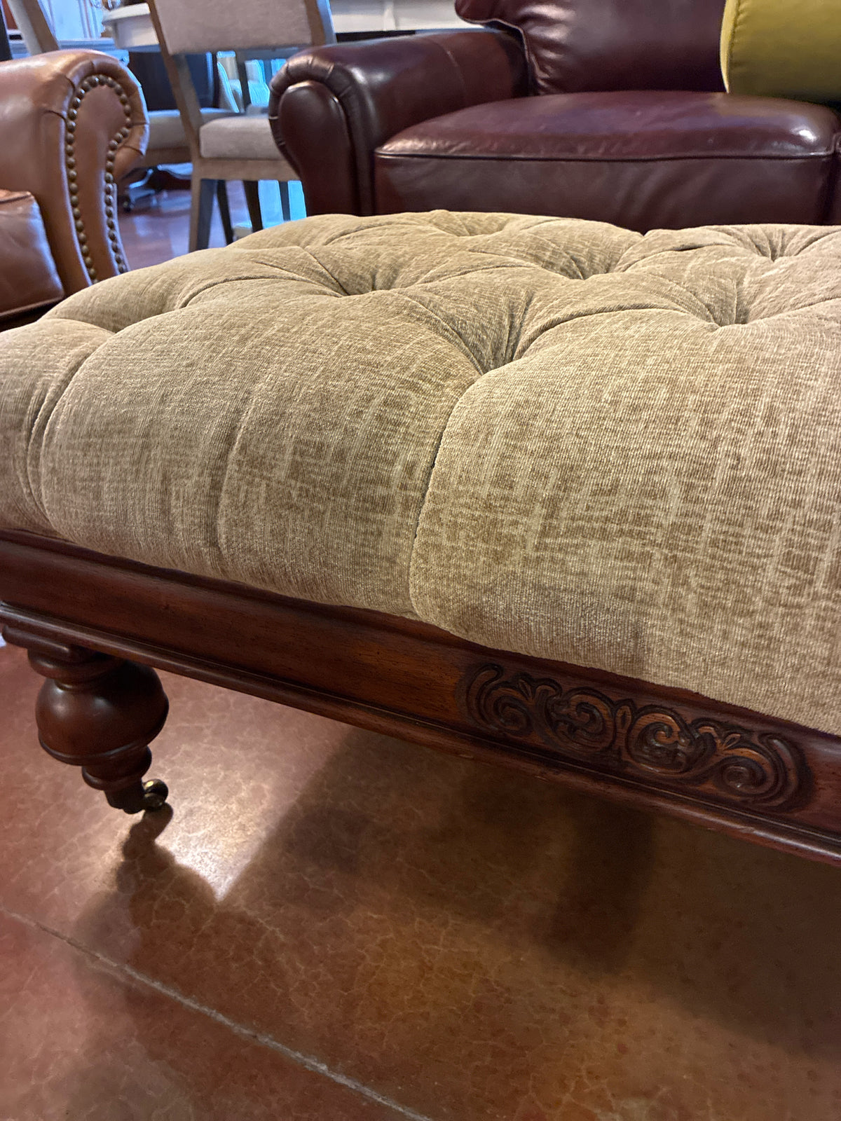 Ottoman|Elegant|Tufted Upholstered|Carved wood apron, turned legs, casters